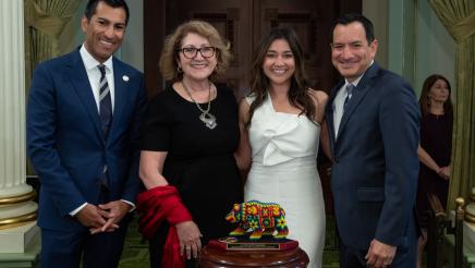 Asm. Robert Rivas presents a Latino Spirit Award to Jenna Contreras