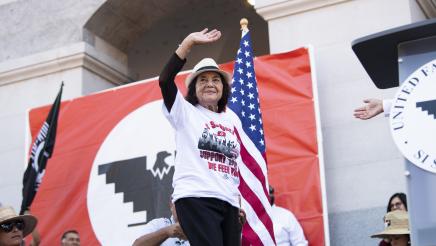 Civil rights and labor activist Dolores Huerta waves to supporters.